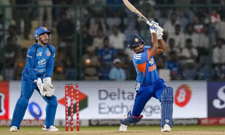 Indian cricket players in action during a match, one batting and one wicketkeeper behind the stumps.