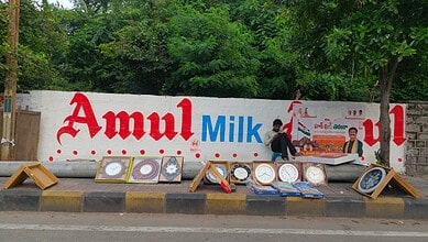 Broken billboard advertising Amul Milk with damaged frames on the roadside in Secunderabad.