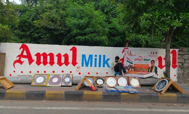 Broken billboard advertising Amul Milk with damaged frames on the roadside in Secunderabad.