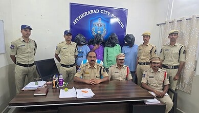Hyderabad City Police officers with detained individuals in police station office.