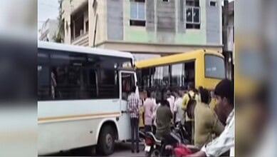 Crowd gathers around a bus after a collision with a school bus in Sircilla, two children injured.