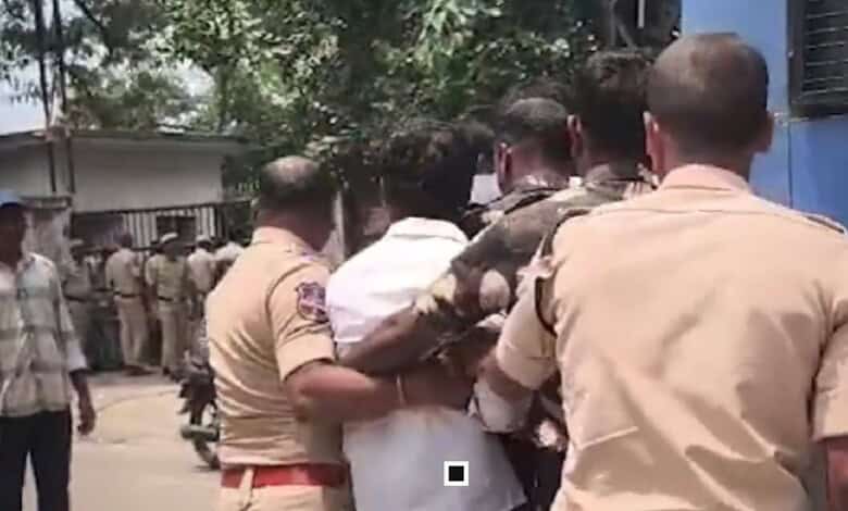 Police detain a man near Ramanthapur Polytechnic College in Hyderabad.