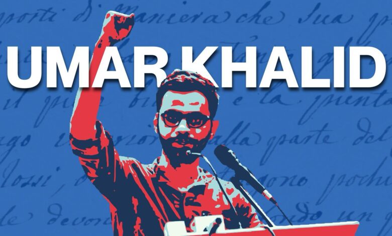 Umar Khalid raising his fist during a speech at a rally or protest.