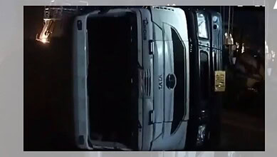 Upside-down bus accident scene in Madhya Pradesh's Rewa at night.