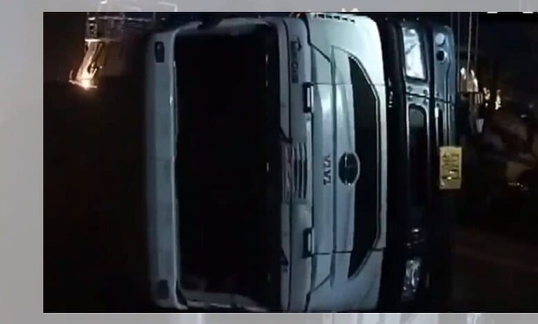 Upside-down bus accident scene in Madhya Pradesh's Rewa at night.
