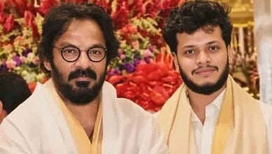 Telugu art director Anand Sai's son with his father at a celebratory event.