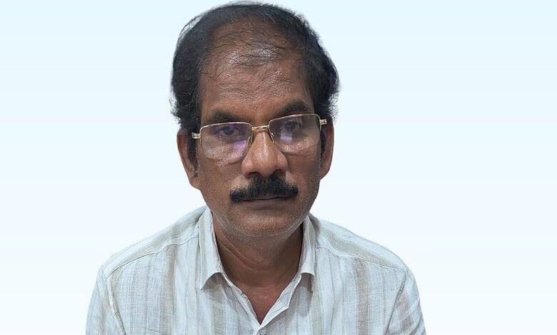 Suryapet town planning officer in formal attire with glasses and mustache.