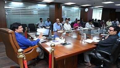 Business meeting with multiple participants in a modern conference room.