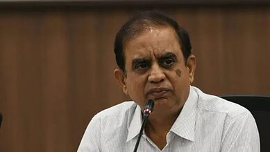 Telangana CEO during a formal meeting or press conference, speaking into a microphone.