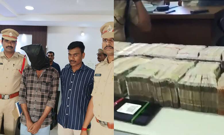 Man held for burglary in Hyderabad with Rs 24.5 lakh recovered, surrounded by police officers.