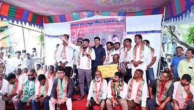 Ex-RTC employees protest in Hyderabad over unpaid dues, holding banners and speaking to crowd.