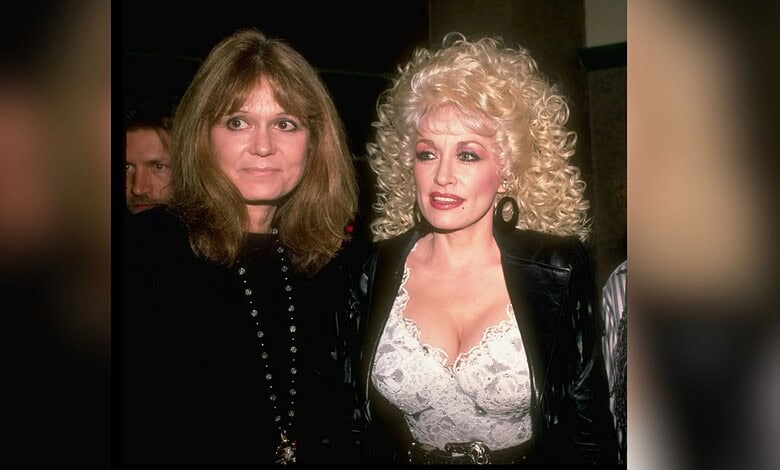 Two women with distinct hairstyles and fashion styles at a social event.
