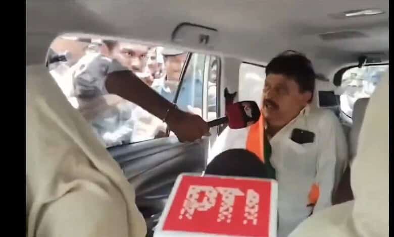 Telangana BJP chief detained during fee reimbursement protest, surrounded by media and supporters.