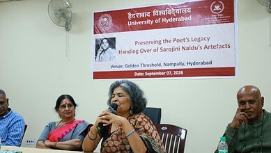 Woman speaking at a university event on preserving poet's legacy in Hyderabad.