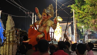 Large idol of Lord Ganesha during Ganesh Chaturthi celebration at night.