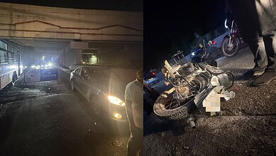 Motorcycle accident scene at night with damaged bike and nearby vehicles in Hyderabad.