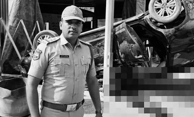 Police officer at the scene of a car accident with an overturned vehicle in black and white.