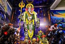 Large Lord Ganesha idol with cityscape backdrop and robotic mice in Hyderabad.