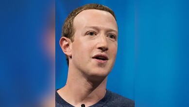 Mark Zuckerberg speaking at an event with a blue background.