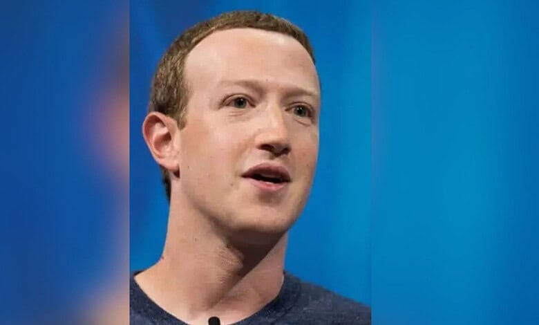 Mark Zuckerberg speaking at an event with a blue background.