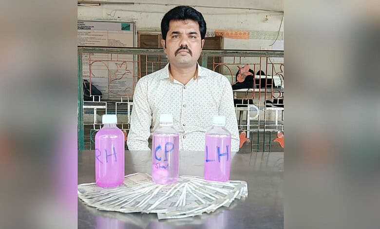 Man sitting behind bottles labeled 'RA', 'CP', and 'LH' with cash in front, in an indoor setting.