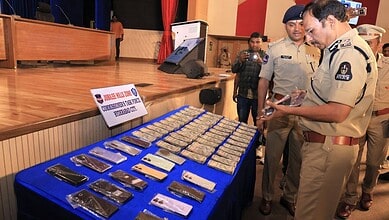 Hyderabad Police Commissioner VC Sajjanar looks at the recovered mobile phones