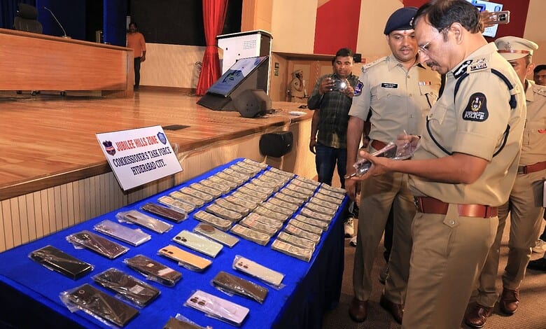 Hyderabad Police Commissioner VC Sajjanar looks at the recovered mobile phones