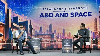 Telangana's strength highlighted at A&D and Space event with speakers on stage.