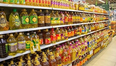 Variety of edible oils on supermarket shelves in India.