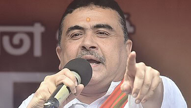 Indian politician speaking into a microphone during a public event.