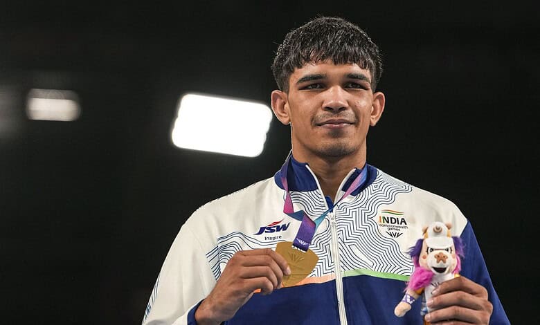 Indian boxer Ankush Panghal with a medal and mascot at the Asian Games.