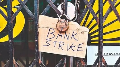 Bank strike sign hanging on a gate with a padlock, symbolising a protest or strike action.
