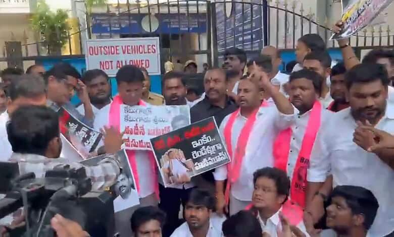 BRS MLAs protest outside Hyderabad ED office during detention, holding placards and banners.
