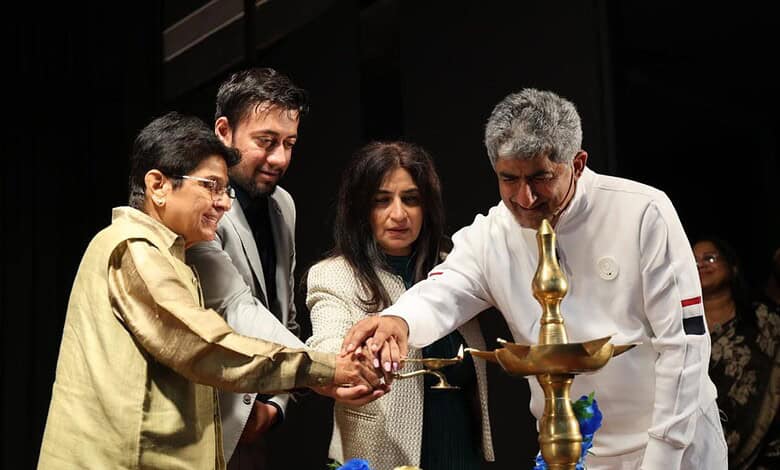 Kiran Bedi lighting a traditional lamp at an event promoting self-discipline and positive thinking.