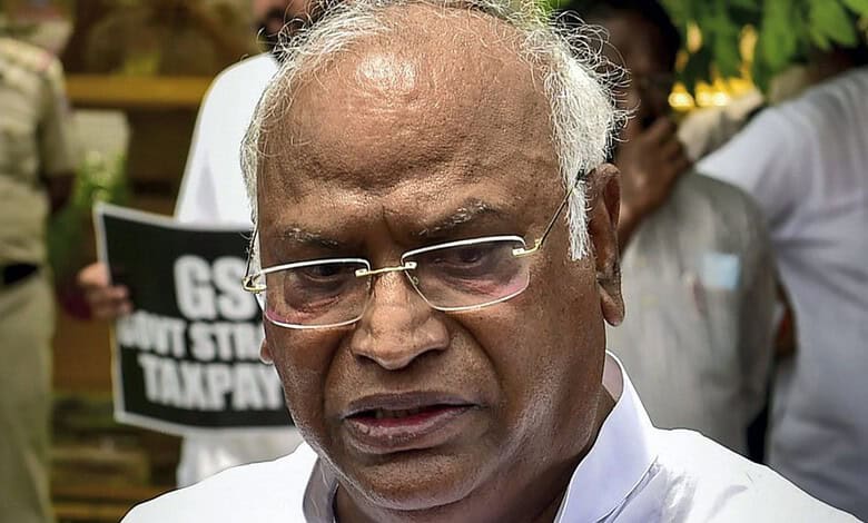 Senior man with glasses and white shirt at a protest or gathering.