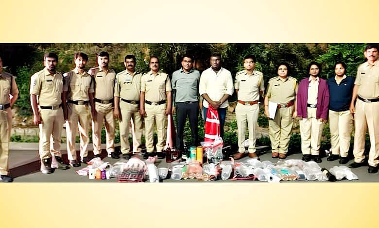 Group of police officers and officials standing outdoors with confiscated items displayed in front.