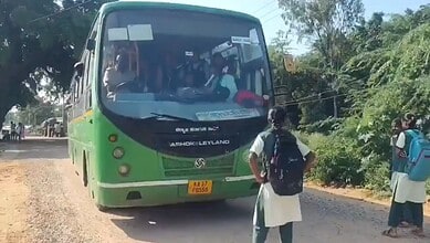Green and black Ashok Leyland bus on rural road with students boarding in Karnataka.
