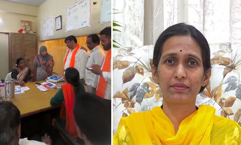 Women and men in a meeting room, some wearing orange scarves, discussing documents.