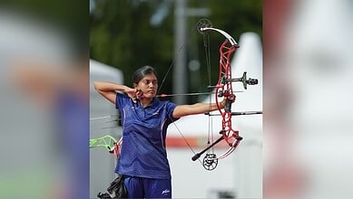 Telangana archer aiming with a bow during a competition at the Asian Games.