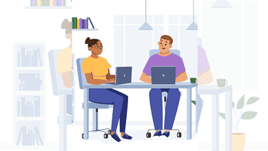 Two professionals working on laptops in a modern office setting.