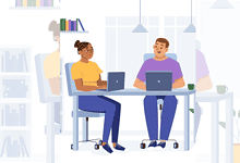 Two professionals working on laptops in a modern office setting.