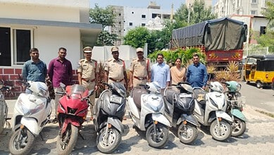 Police officers and civilians with seized motorcycles in Hyderabad.