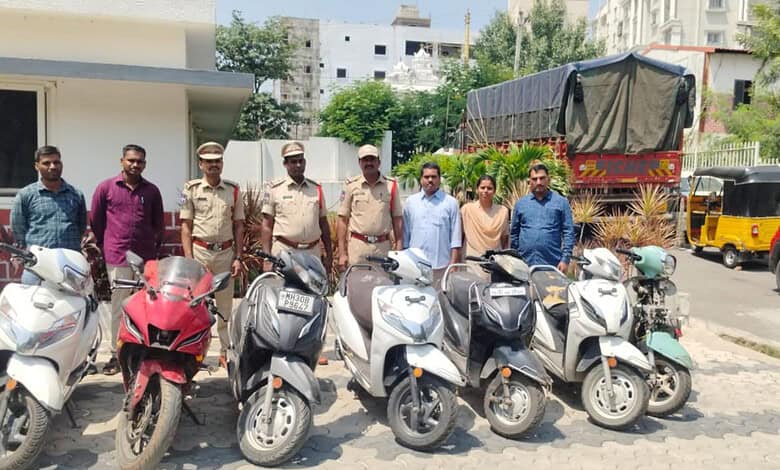 Police officers and civilians with seized motorcycles in Hyderabad.