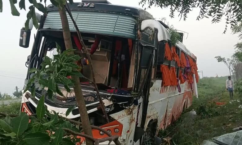 Damaged bus after overturning in Suryapet, with visible injuries and debris around.