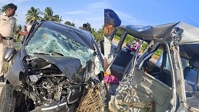 Two damaged vehicles after a collision, with police and bystanders at the scene.