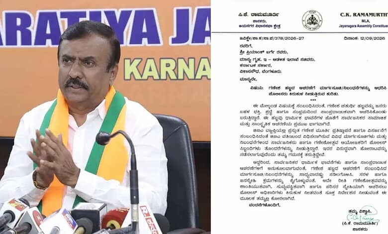 C.K. Ramamurthy speaking at a press conference with microphones in front of him.