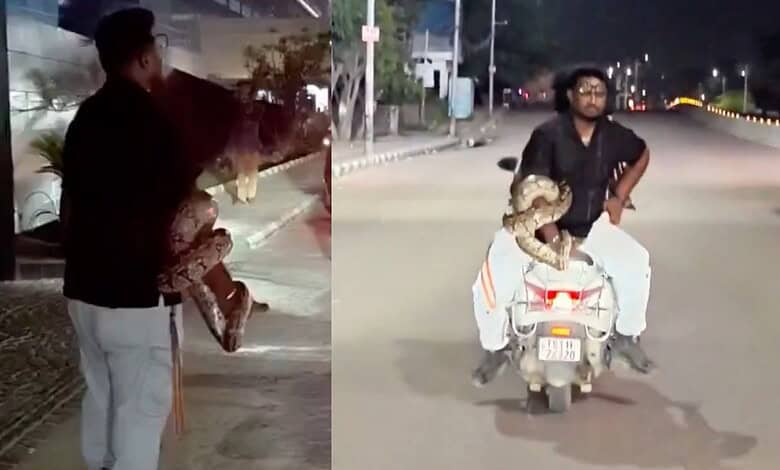 Man riding a scooter with a child at night near Durgam Cheruvu, Hyderabad.