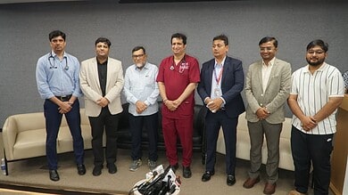 Group of seven men standing together in a professional setting at Siasat Daily.