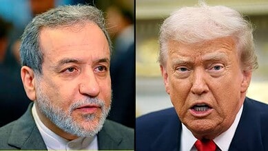 Close-up of two political figures, one with grey hair and beard, the other with blonde hair, speaking.