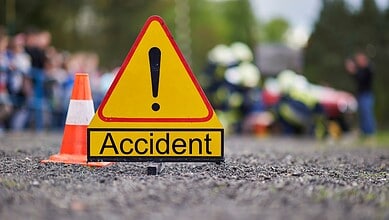 Warning sign with exclamation mark and cones at accident site in Hyderabad.